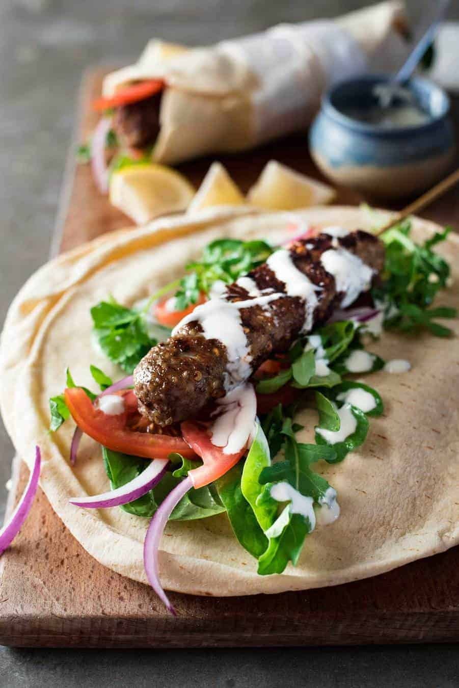 Turkish Lamb Kebab Kofta on pita with vegetables and yoghurt sauce