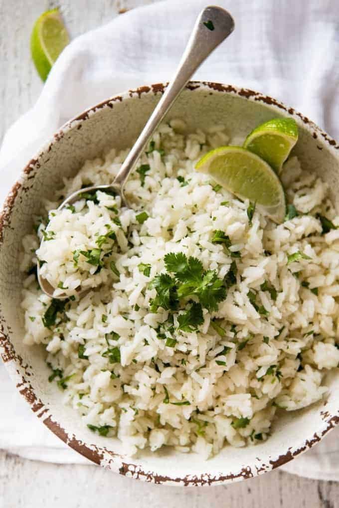Coconut Cilantro Lime Rice in a bowl with a spoon, ready to be served.