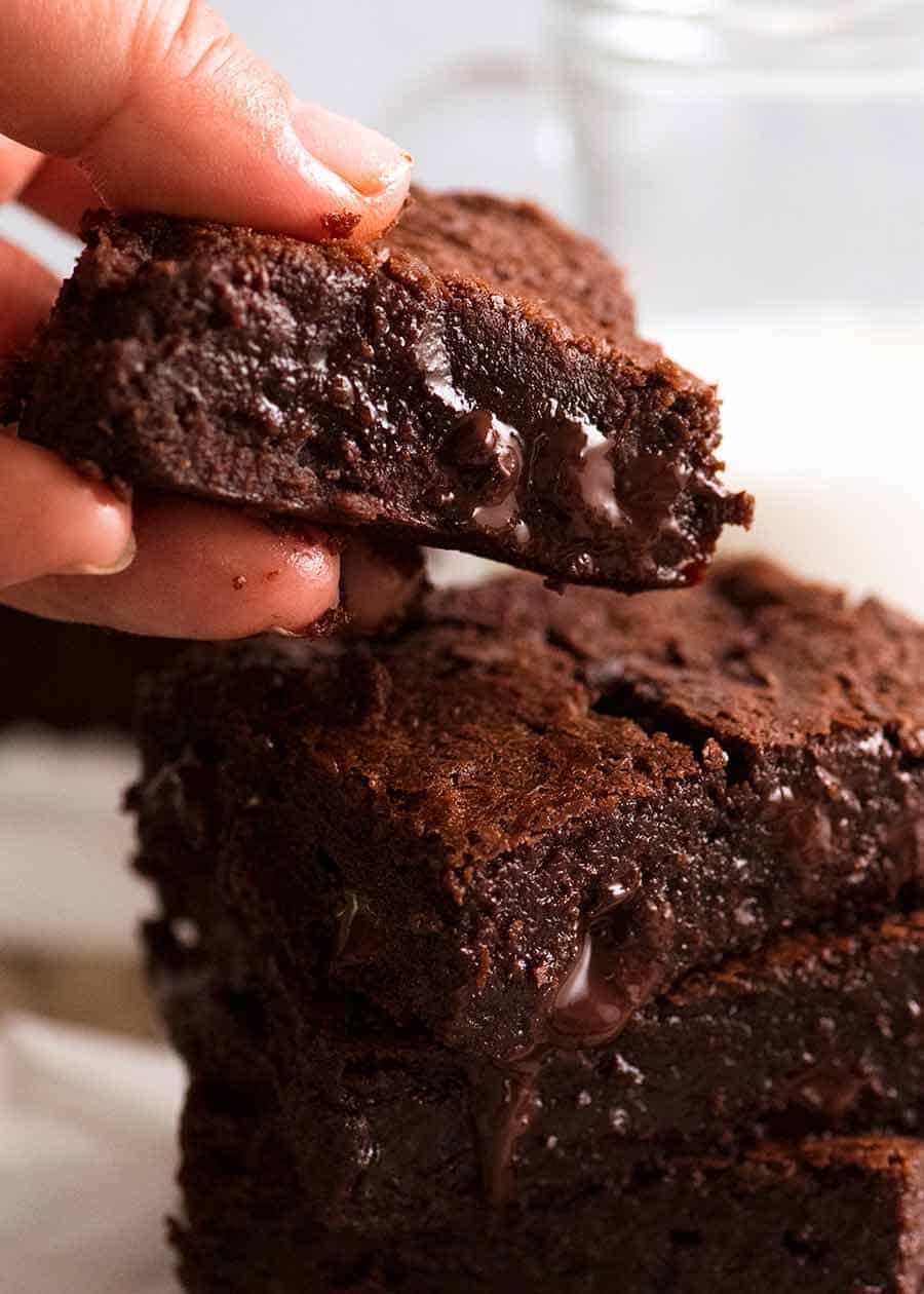 Hand picking up chocolate brownies