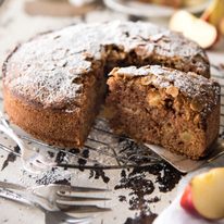 Apple cake on a white cake stand, ready to be served