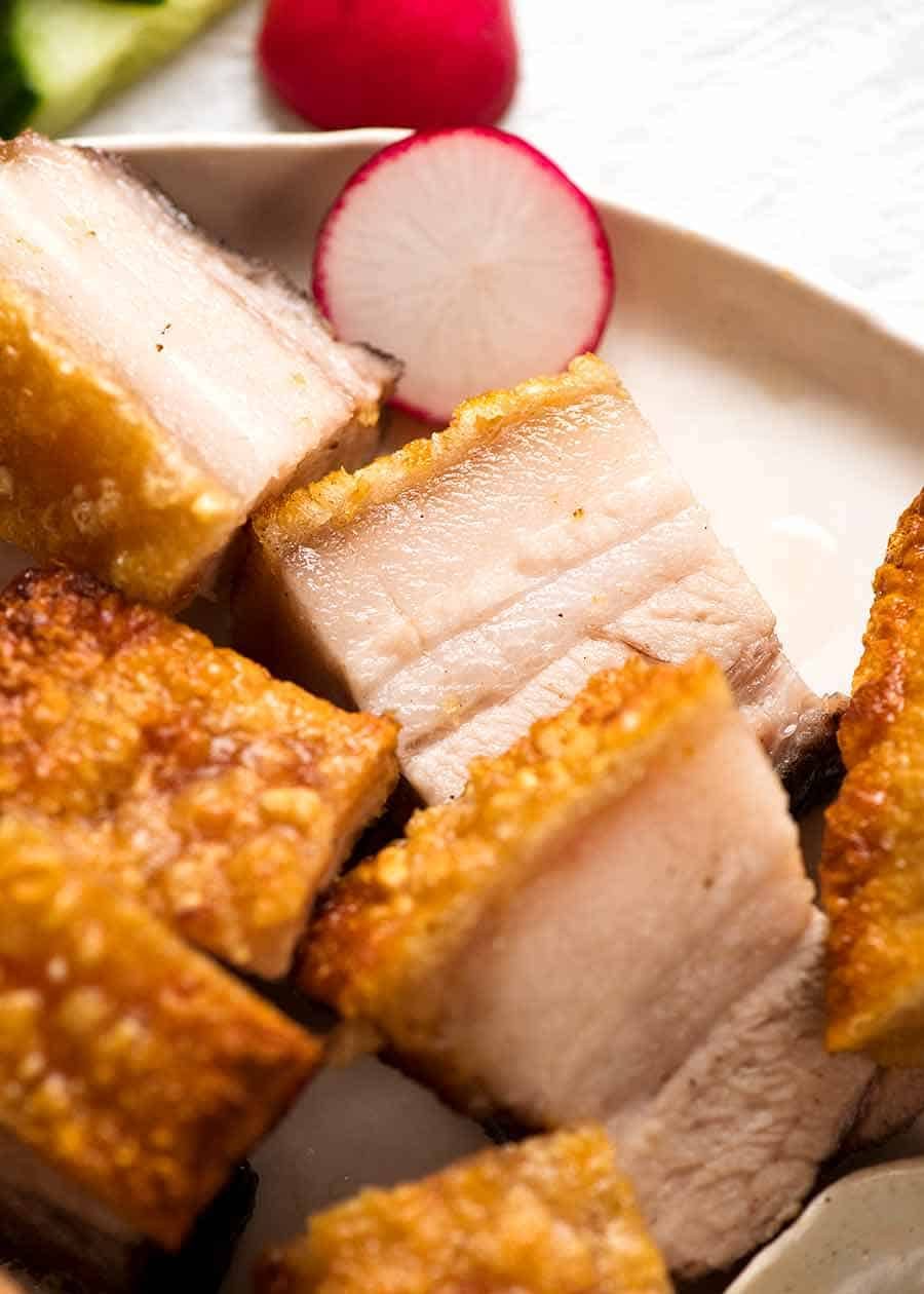 Plate with slices of Chinese Crispy Pork Belly with the best crackling in the world