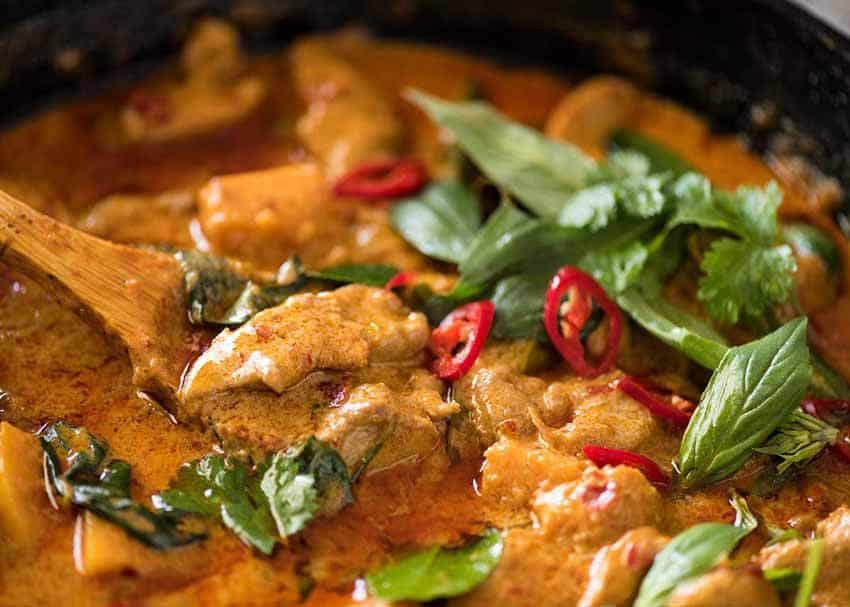 Close up of Thai Red Curry with Chicken in a black skillet