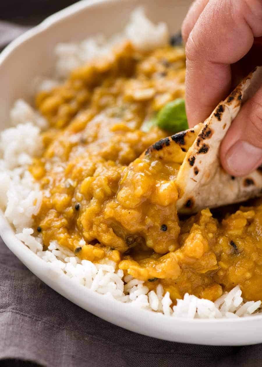 Dal being scooped up by Chapati