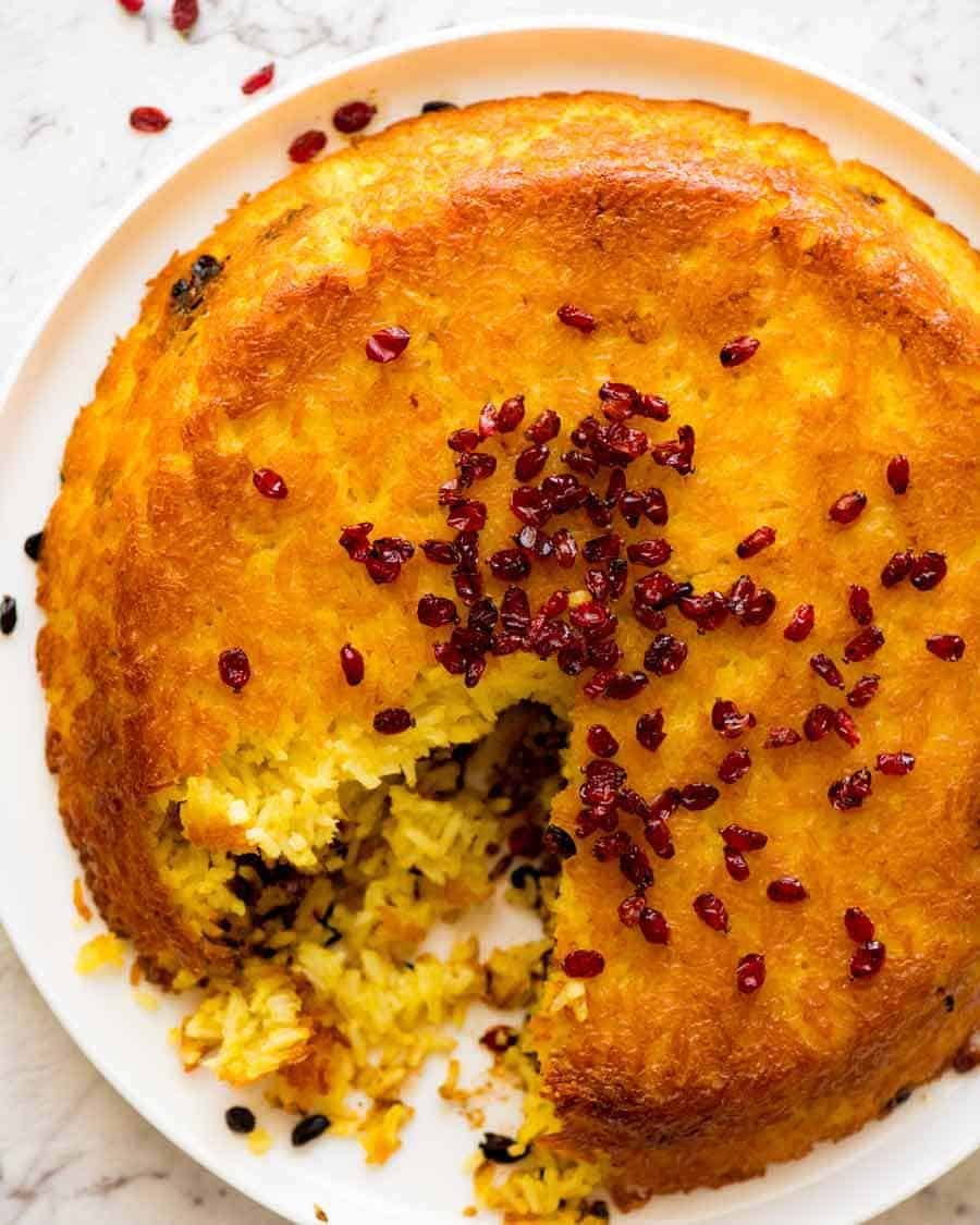 Overhead photo of Tachin Persian Saffron Rice sprinkled with barberries