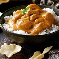 Butter Chicken served over basmati rice in a bowl, ready to be served