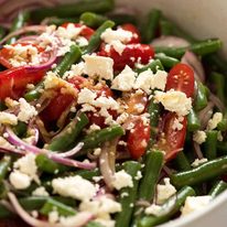 Close up of Green Bean Salad with Cherry Tomatoes and Feta in a white salad bowl, ready to be served