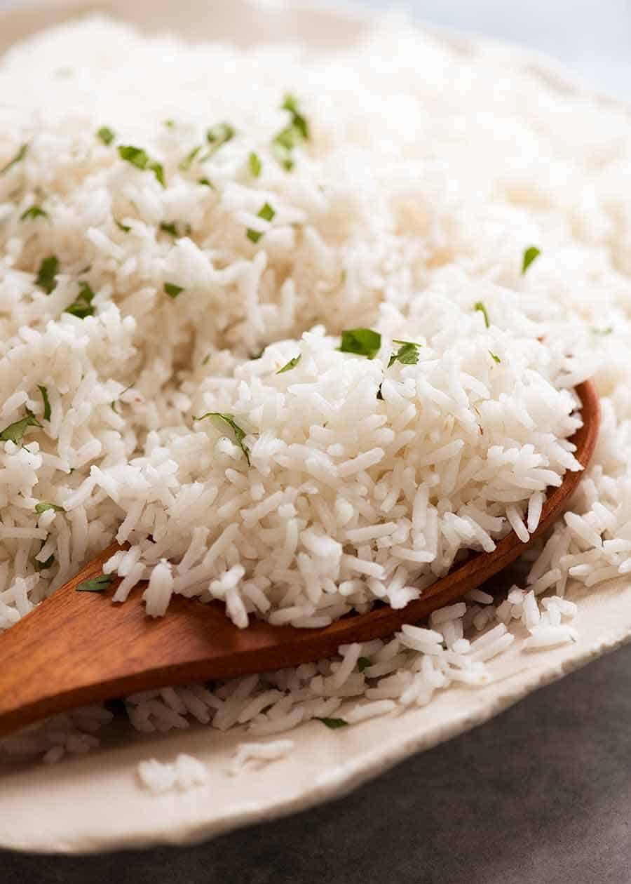 Close up of spoon scooping up fluffy Basmati Rice
