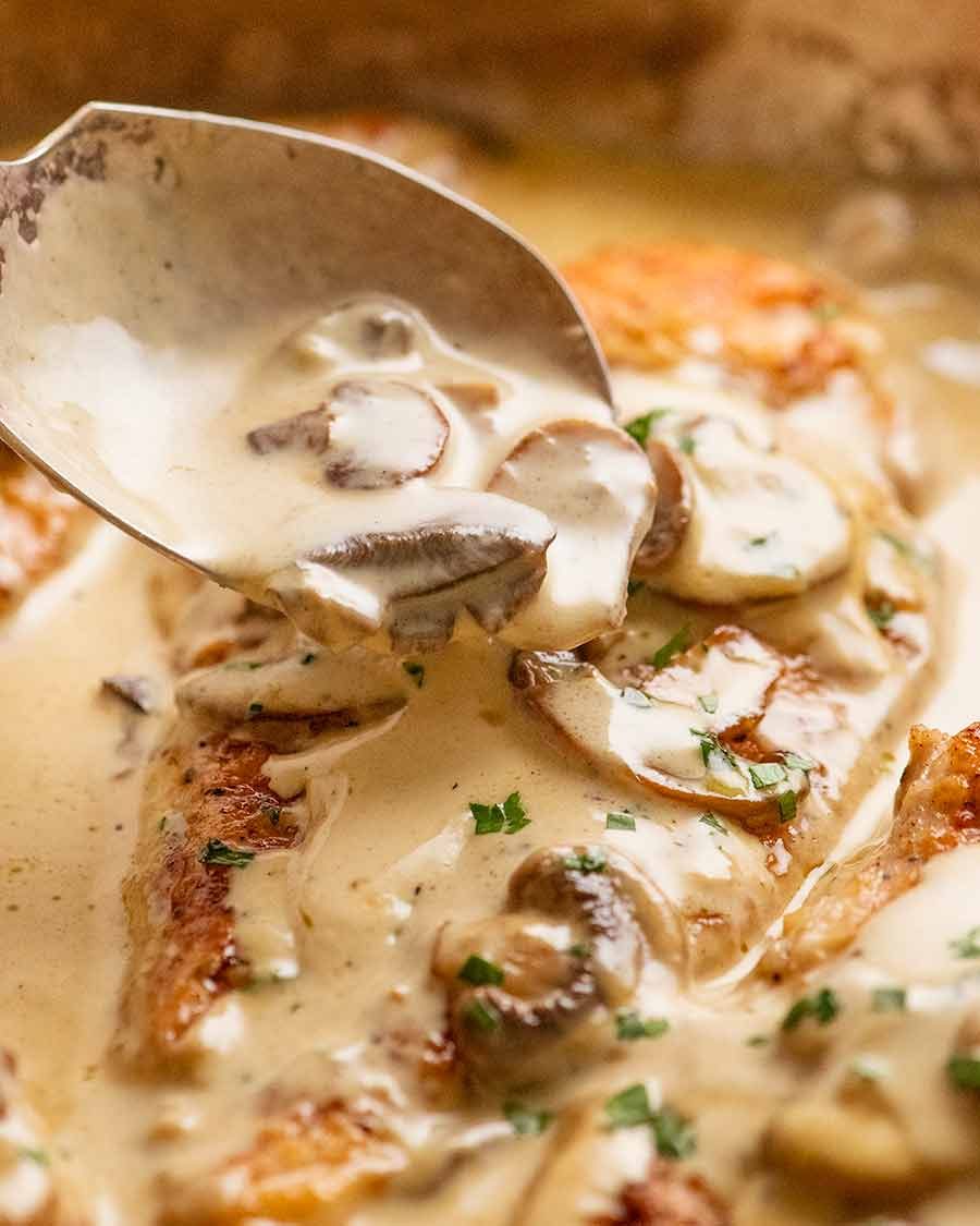 Spooning Creamy Mushroom Sauce over Chicken breast