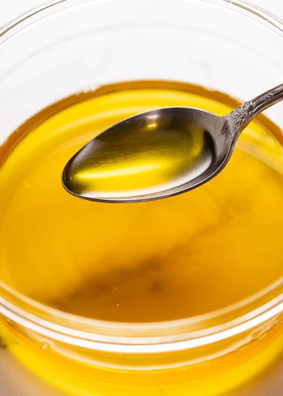 Spoon scooping up homemade ghee
