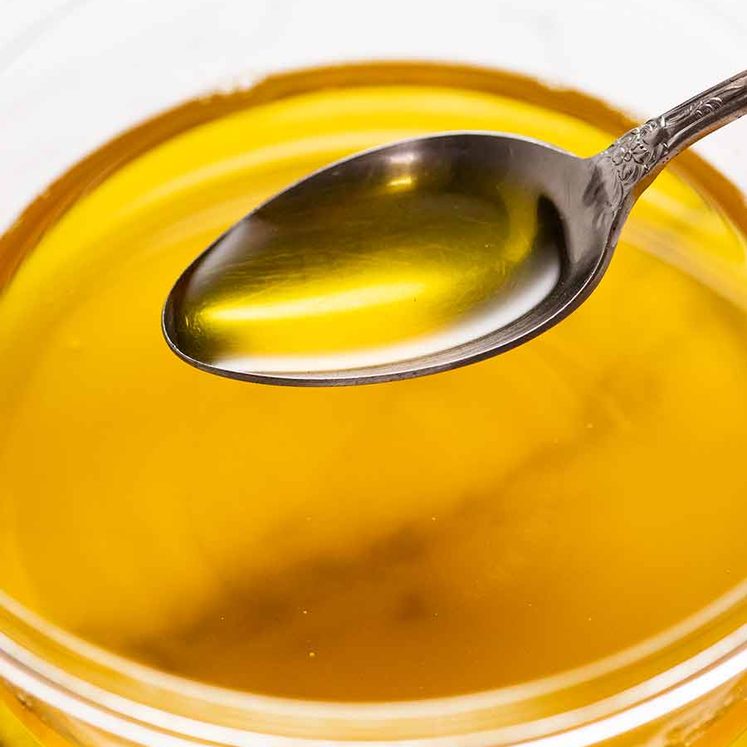 Spoon scooping up clarified butter