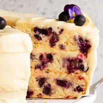 Slice of Blueberry Cake with Lemon Cream Cheese Frosting on a plate